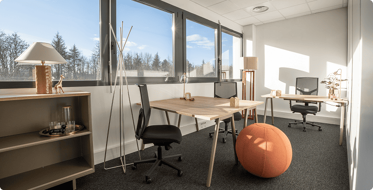 Bureau privé lumineux du centre B'CoWorker à Saint-Priest avec trois postes de travail, grandes fenêtres et mobilier contemporain, BMG Foncière.